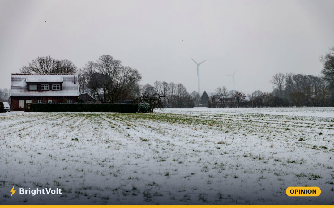 Wind turbines standing in a snow-covered winter landscape