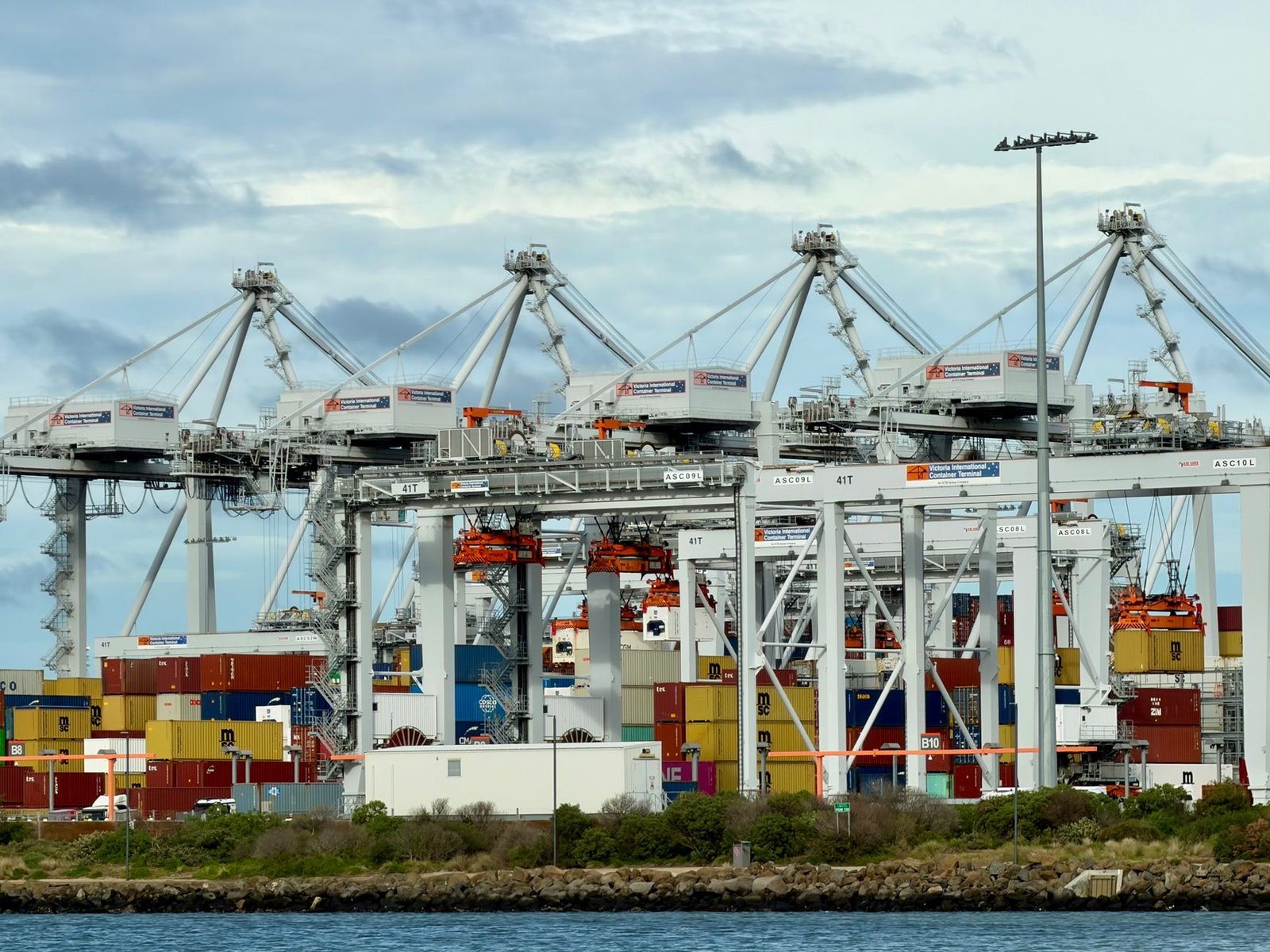 Container terminal with ship-to-shore gantry cranes and stacked containers