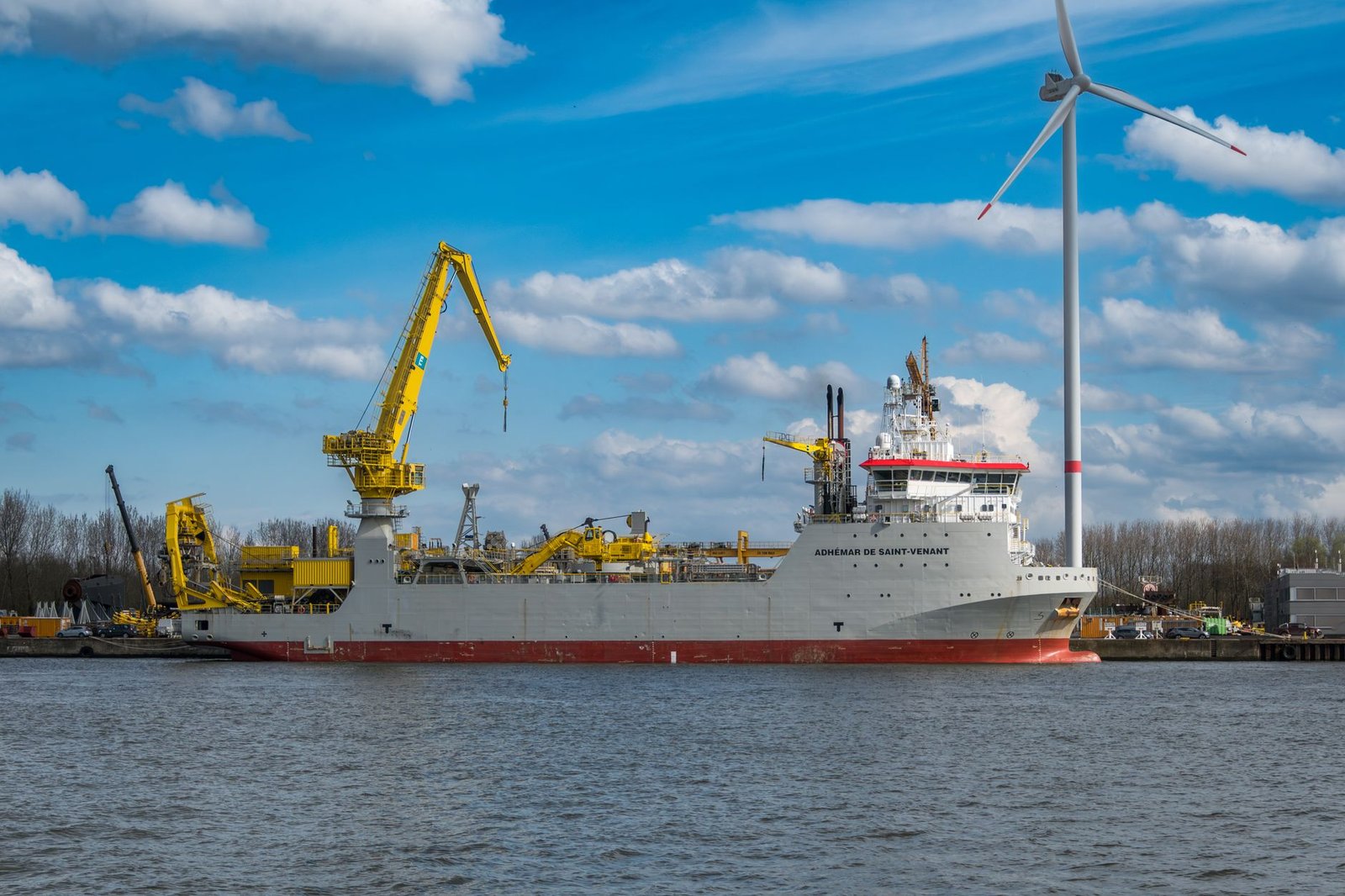 A jack-up installation vessel lifting an offshore wind turbine component at sea