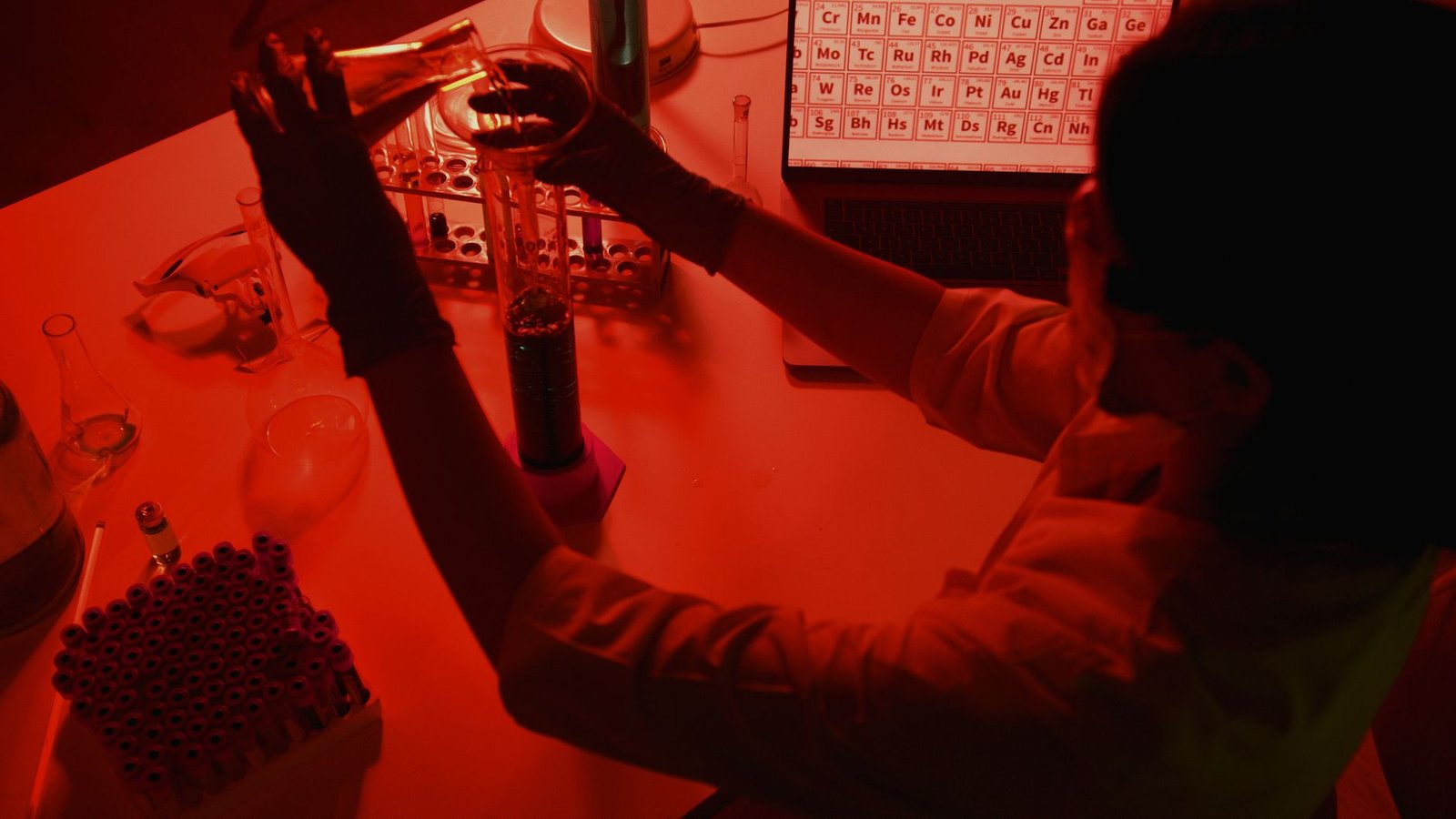 A researcher working on battery cells at a laboratory bench