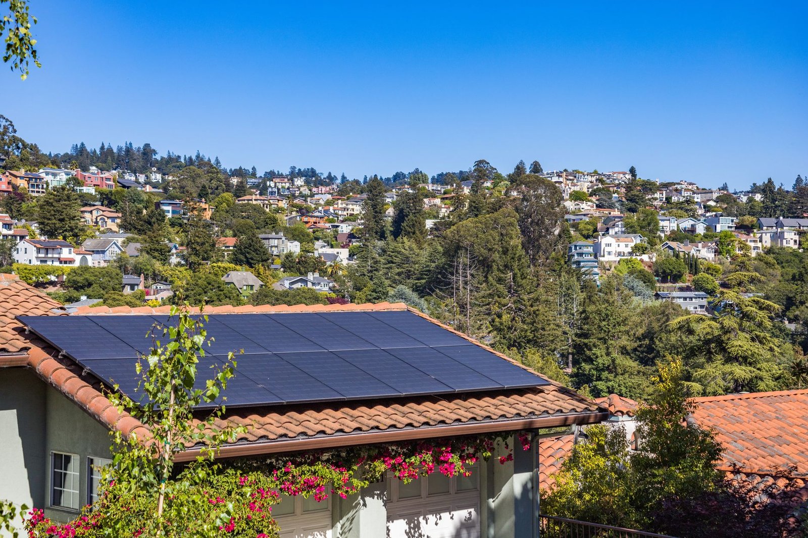 Rooftop solar panels on the roofs of suburban houses