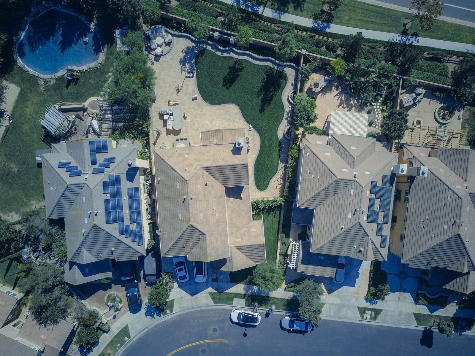 A residential rooftop solar array with a wall-mounted home battery unit beside the electrical panel