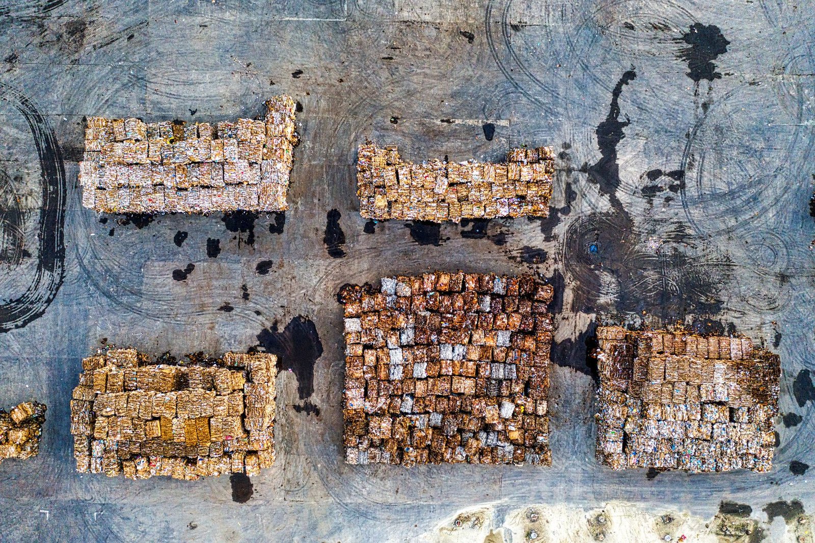 Stacks of retired solar panels awaiting processing at a recycling facility