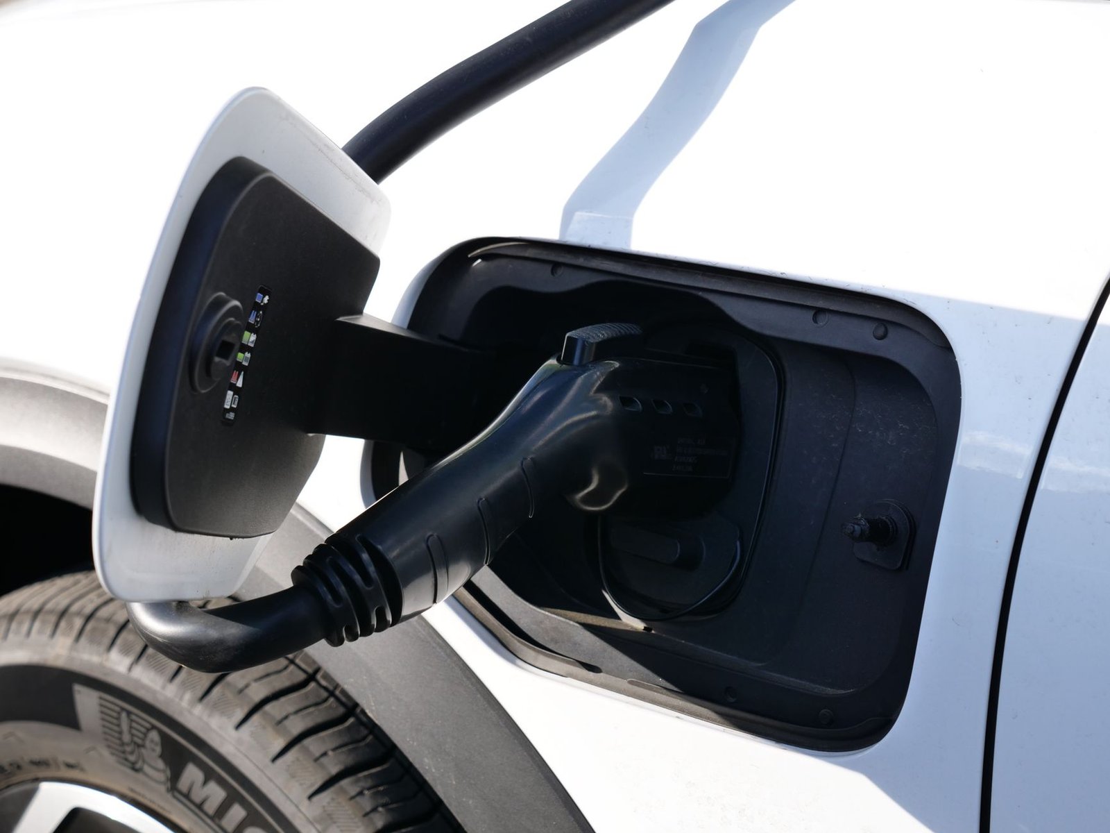 An electric vehicle connected to a high-power DC fast charger