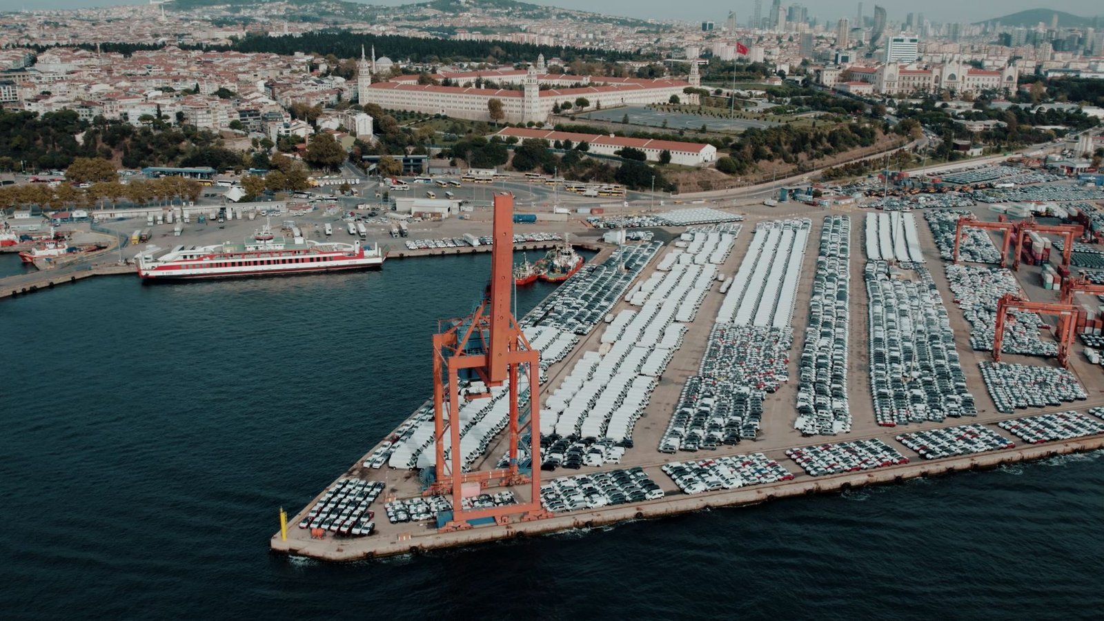 New cars lined up in rows at a vehicle distribution yard