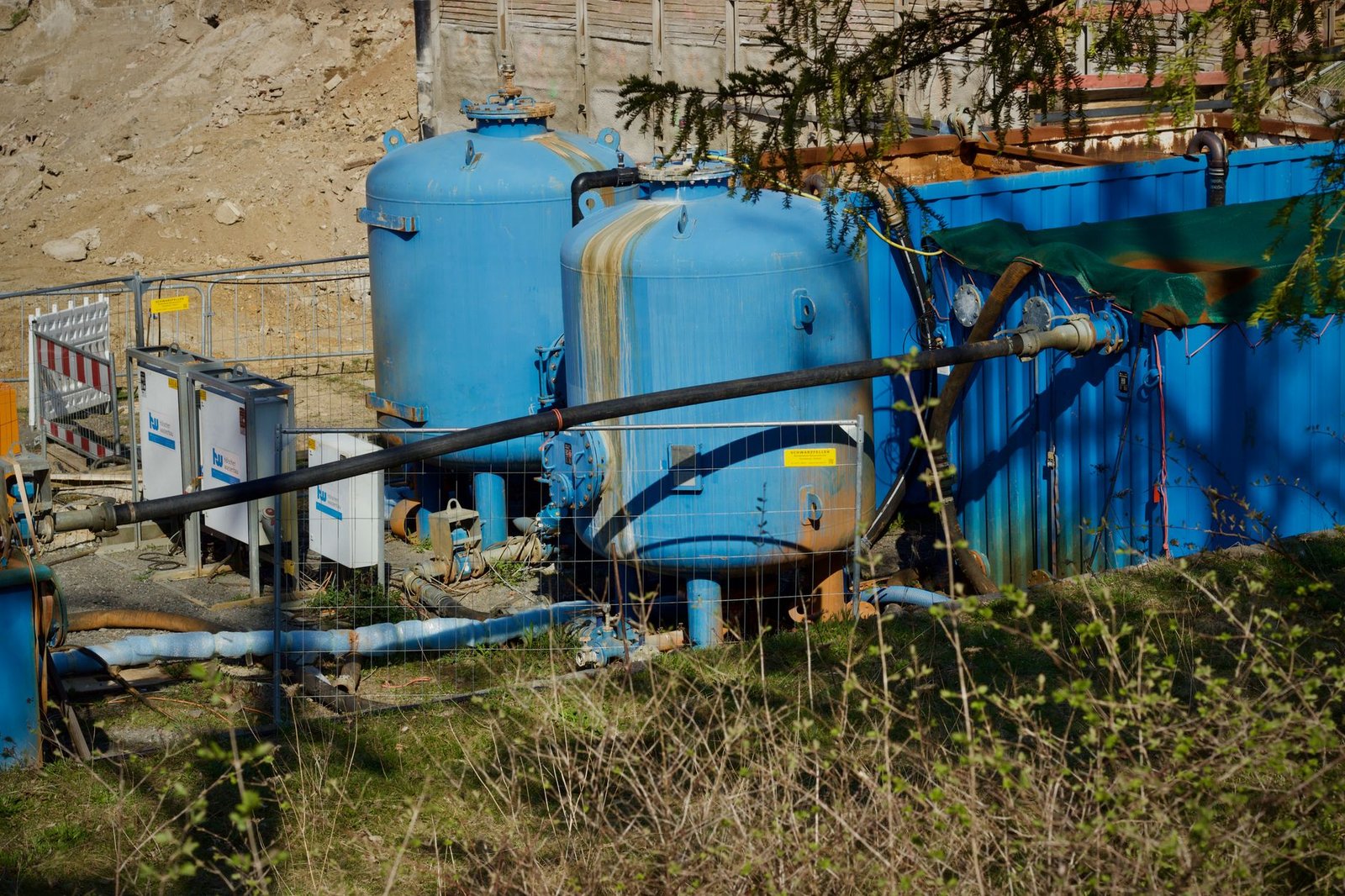 Rows of containerised grid-scale battery units at a storage site