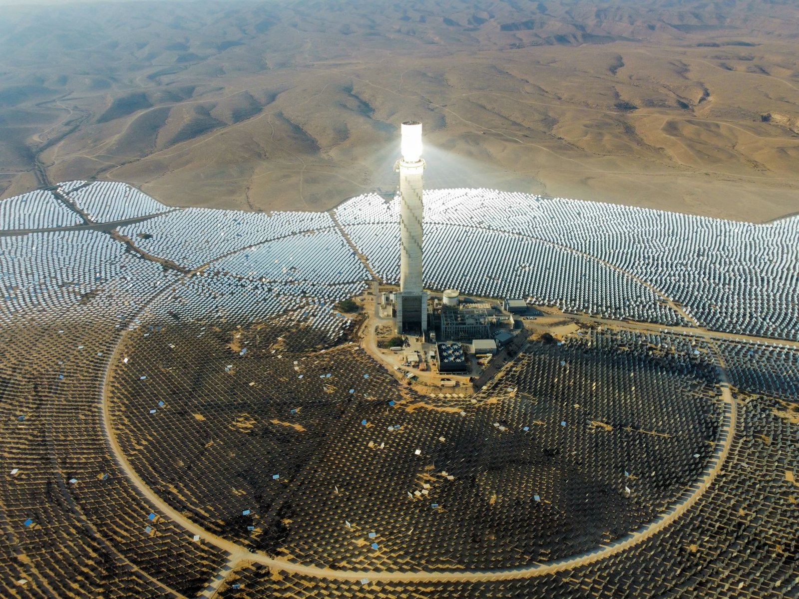 A concentrating solar power tower surrounded by a field of heliostat mirrors
