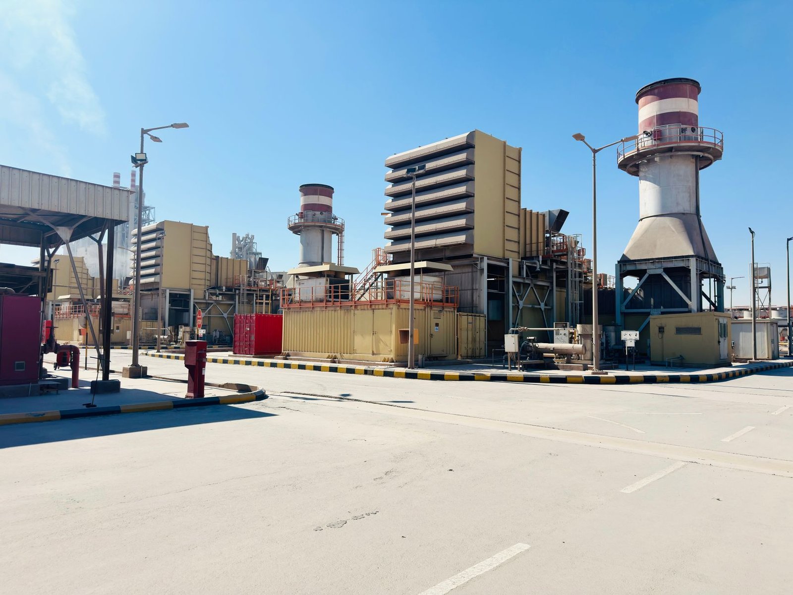 Rows of natural gas turbine generators at an industrial power generation site