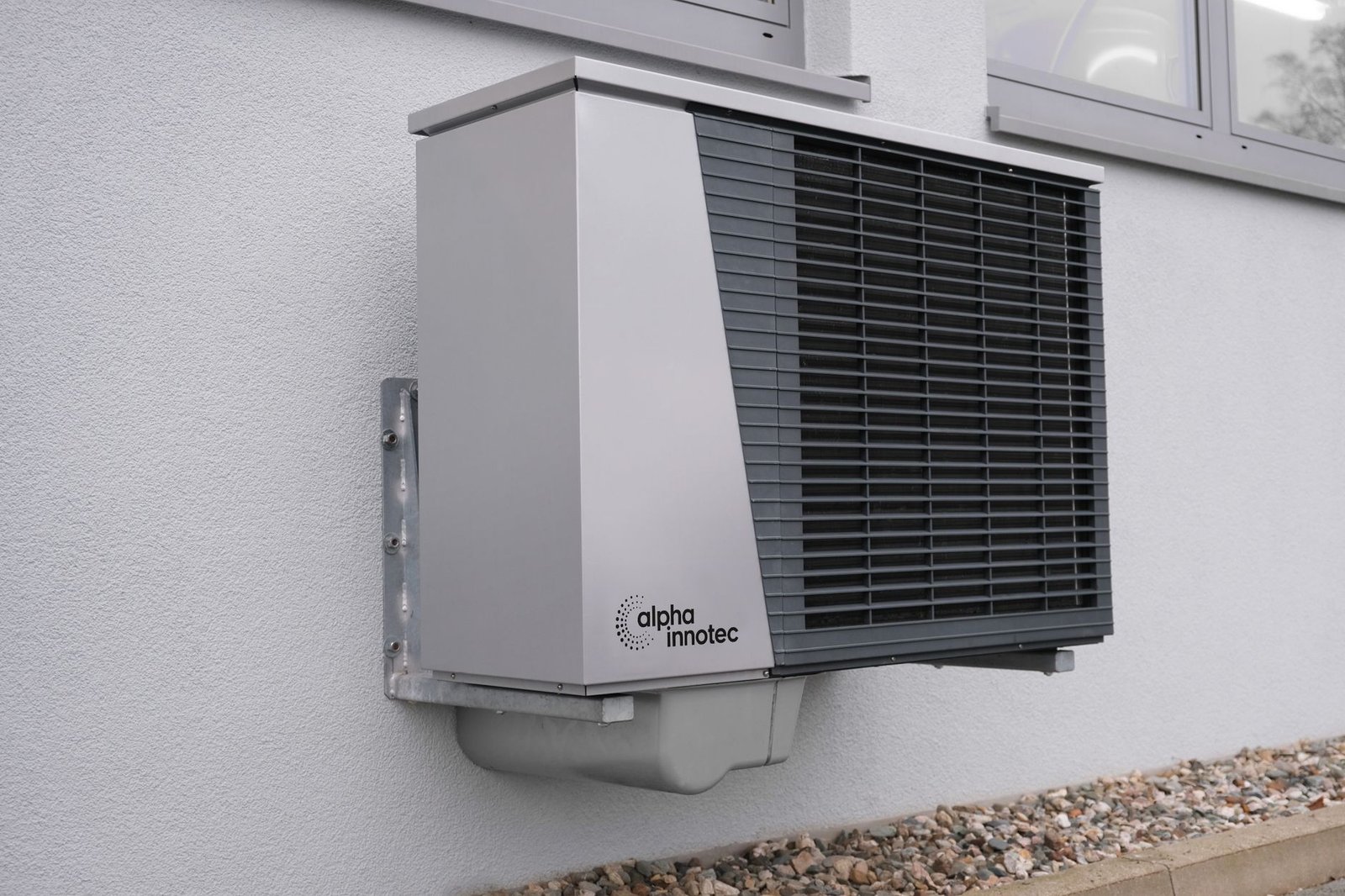 An air-source heat pump unit mounted outside a modern home