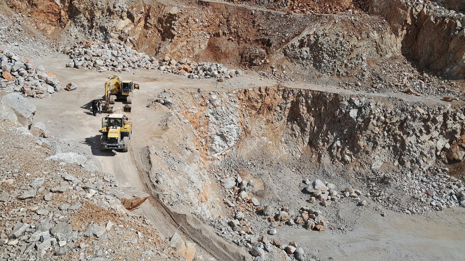 A wheel loader working at an open-pit iron ore mine