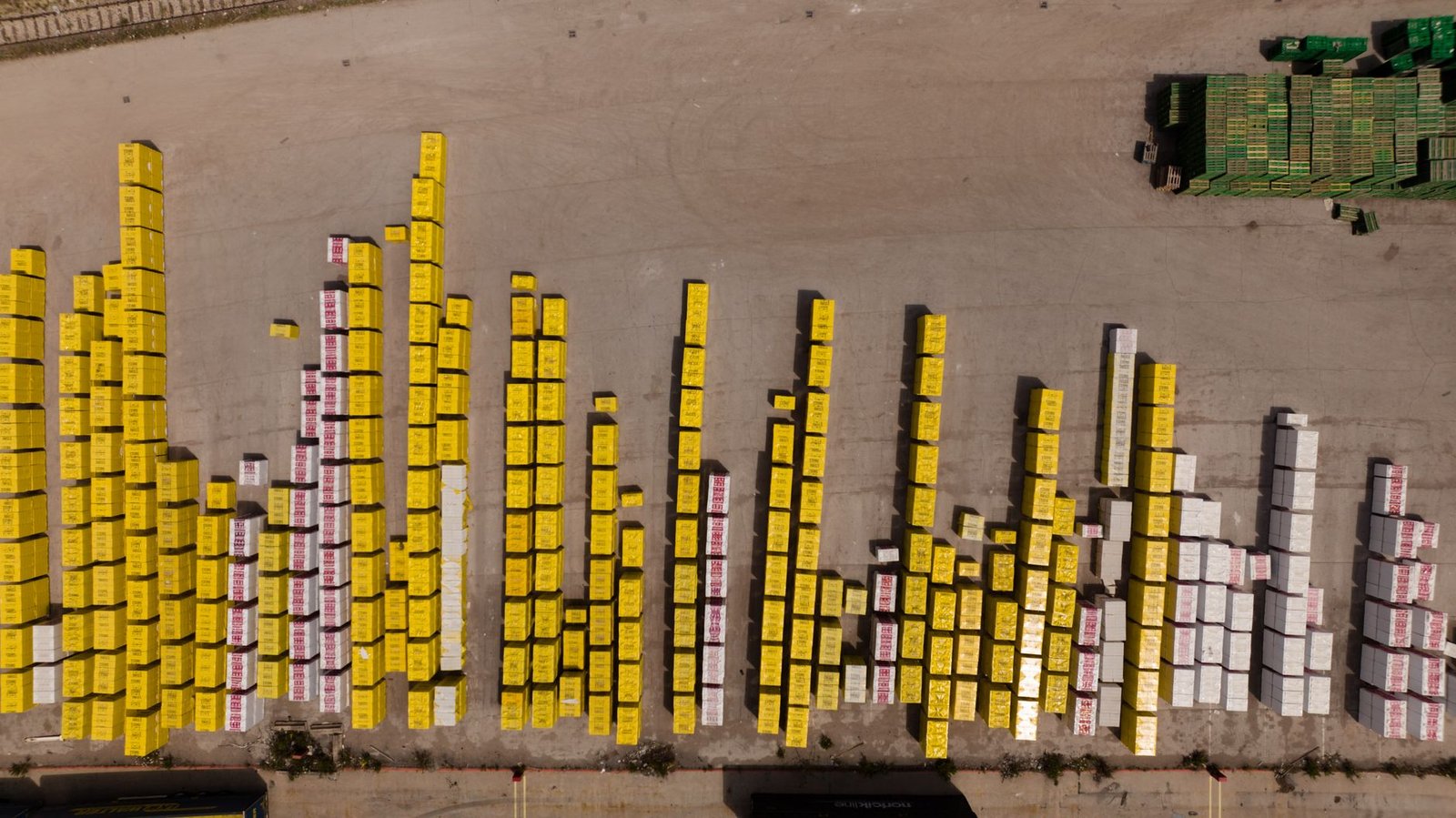 Aerial view of a large grid-scale battery energy storage installation with rows of white battery containers