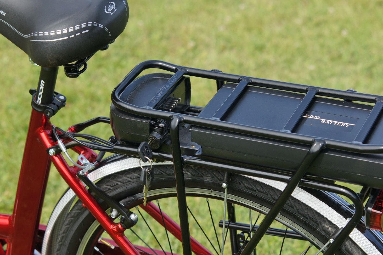 Close-up of a removable e-bike battery pack being slotted into the downtube of an electric bicycle