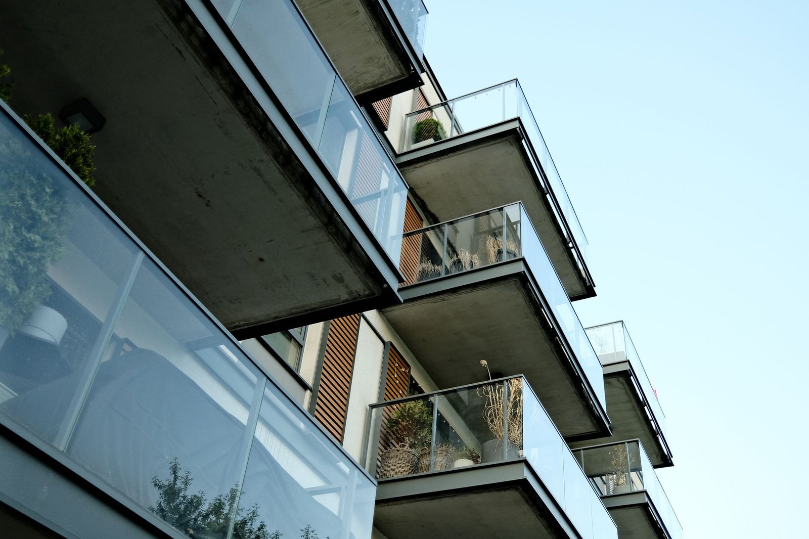 A balcony-mounted solar panel on an apartment railing