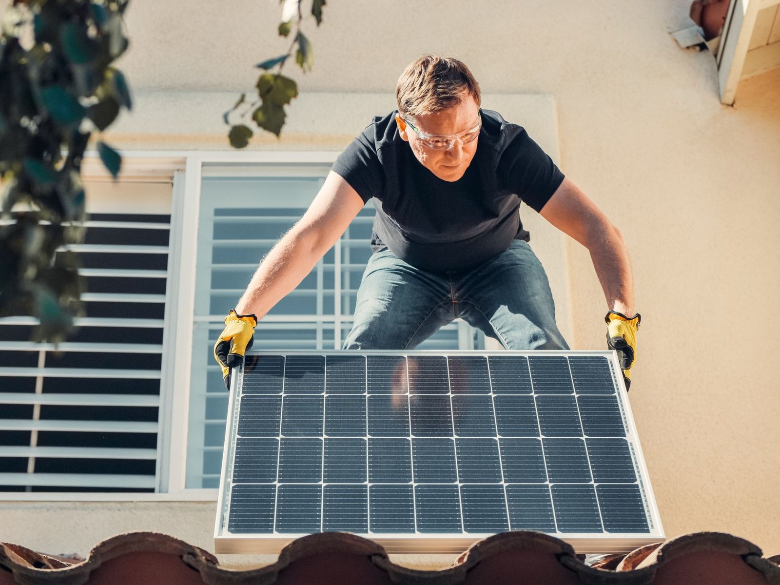 A small solar panel and microinverter being set up outdoors