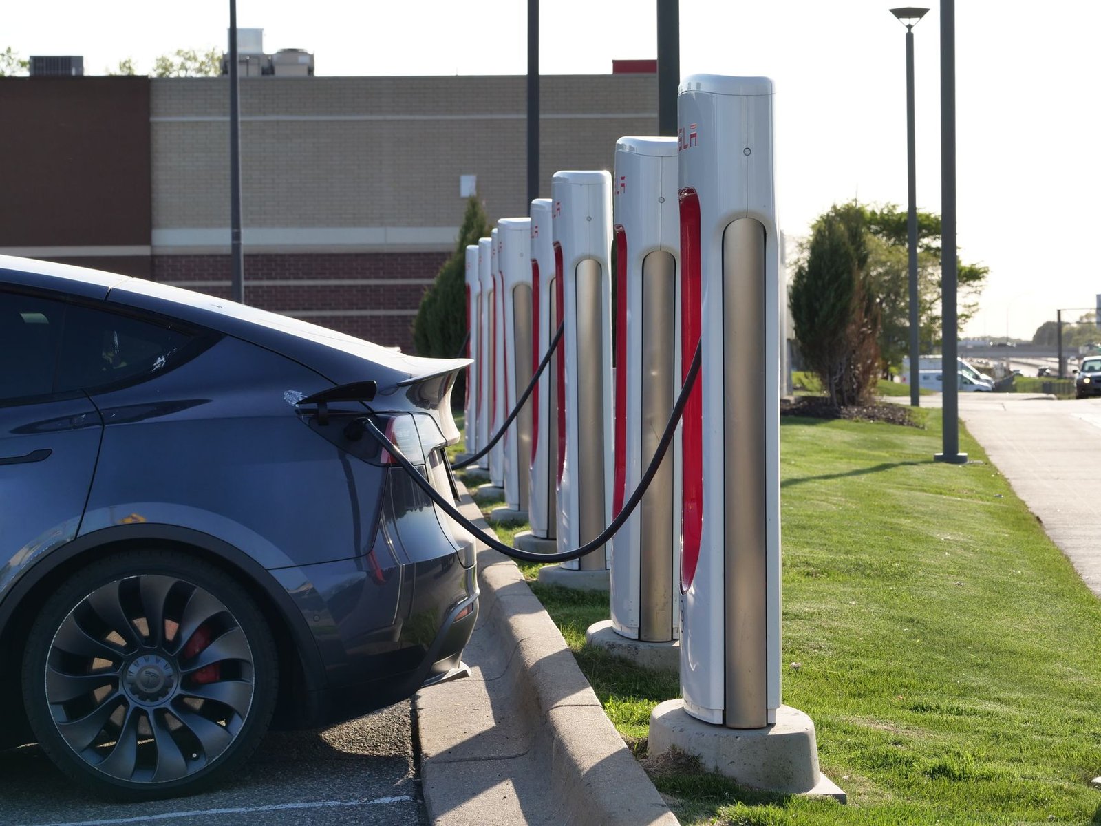 A row of DC fast-charging stalls at a public charging hub